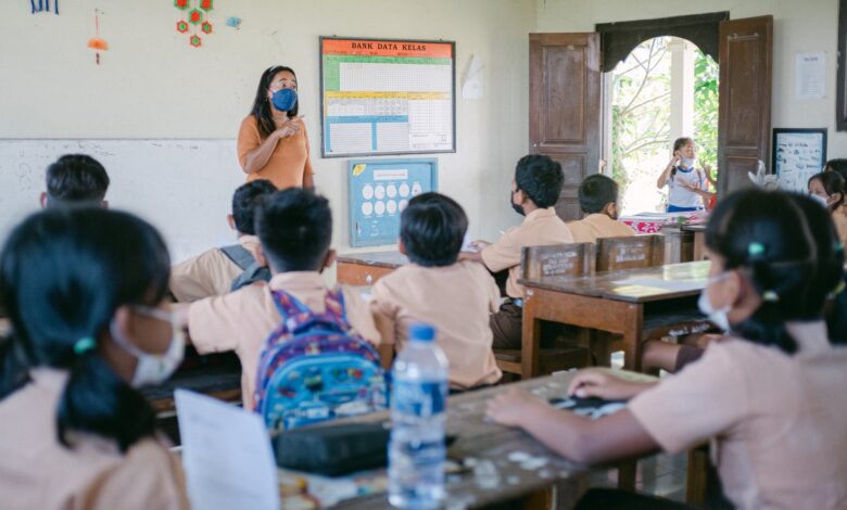 woman teaching children in a classroom